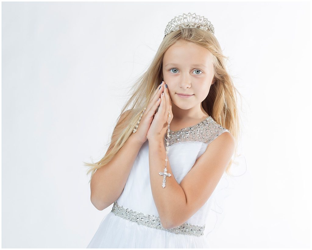 Portrait of child with rosary and first communion tiara