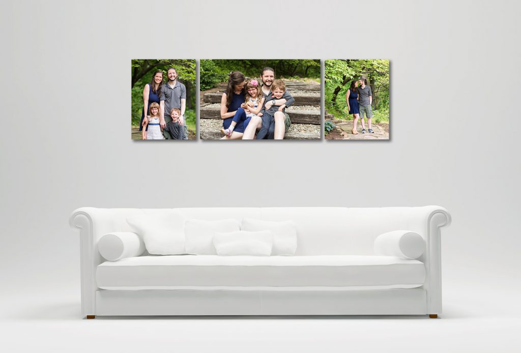 Family portraits hanging over white couch.