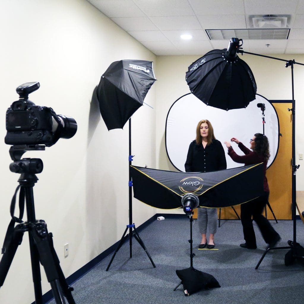 Professional staff headshots with Berks Headshots mobile studio set up in a conference room. 